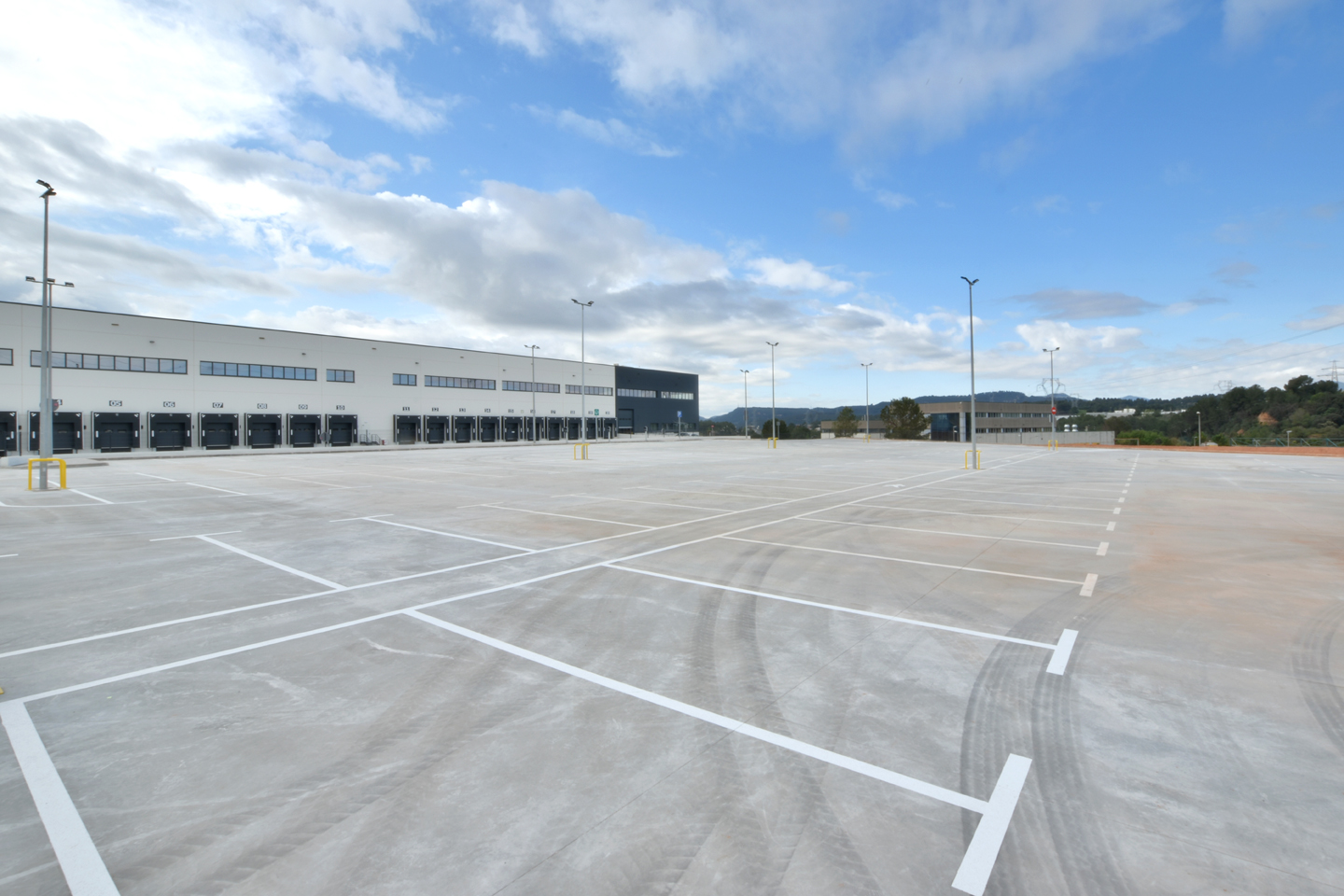 Fachada de la nave, parking externo y muelles de carga