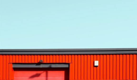 Fachada edificio industrial rojo sobre cielo azul